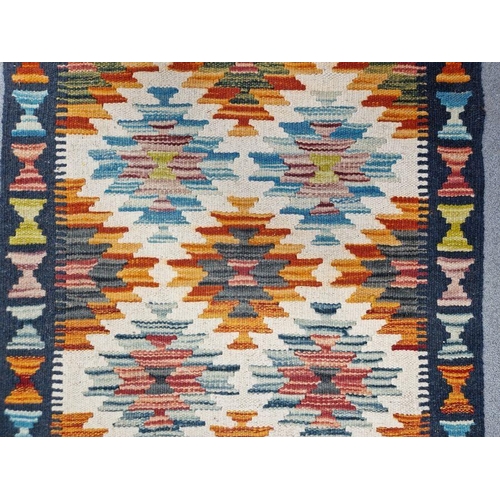 1030 - Cream ground Chobi kilim runner with one row of five geometric medallions flanked by tow rows of six... 