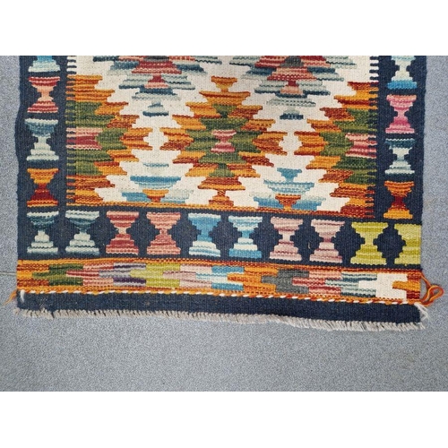 1030 - Cream ground Chobi kilim runner with one row of five geometric medallions flanked by tow rows of six... 