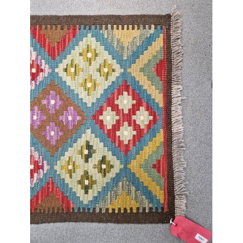 1031 - Blue ground Maimana kilim runner with one central row of nine lozenge floral medallions flanked by t... 