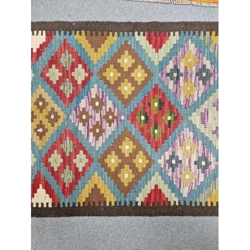 1031 - Blue ground Maimana kilim runner with one central row of nine lozenge floral medallions flanked by t... 