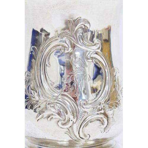 385A - George III silver baluster tankard with double scroll handle, embossed with a centre and engraved wi... 