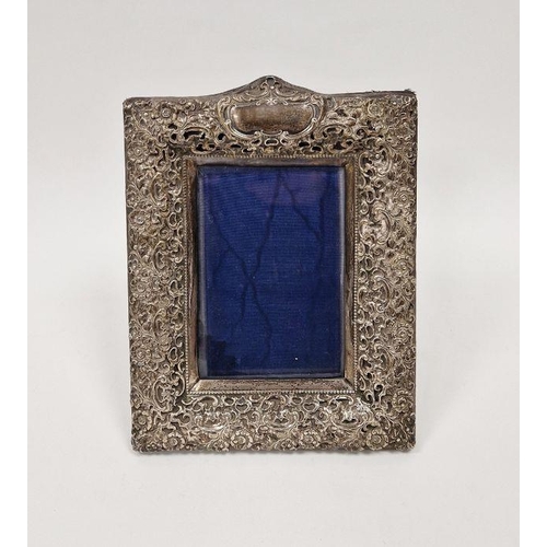 447 - Late Victorian silver photograph frame, with pierced rocaille and floral frame centred by a scroll c... 