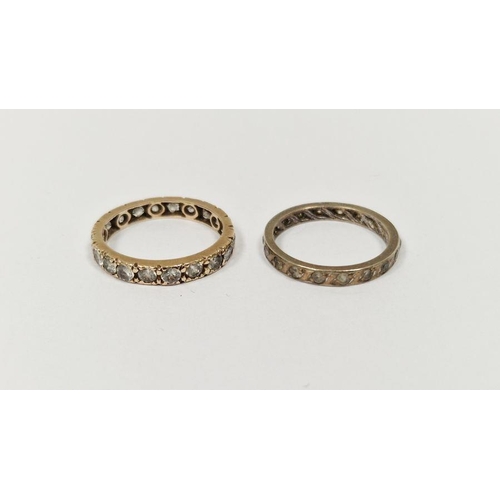 597 - Gold-coloured metal and white stone eternity ring and another metal and white stone eternity ring (2... 