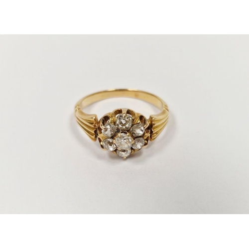 675 - Gold coloured metal and diamond cluster ring having central stone surrounded by six further old cut ... 