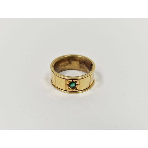 685 - Gold coloured metal and emerald coloured stone ring, the wide band set with single green stone and s... 