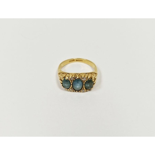 731 - 18ct gold, blue stone and diamond dress ring set three pale blue oval cut stones interspersed by fou... 