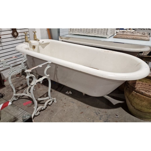 1324 - Vintage cast iron roll-top bath . 208 cms long, with brass taps and integral soap dishes and a cast ... 