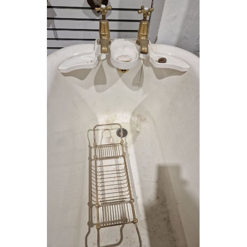 1324 - Vintage cast iron roll-top bath . 208 cms long, with brass taps and integral soap dishes and a cast ... 