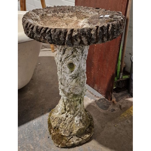 1325 - Composite stone bird bath, the pedestal in the form of a tree trunk, 68cms h.