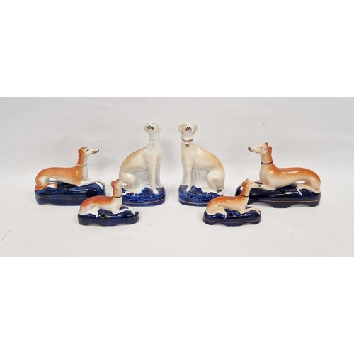 11 - Group of late 19th century Staffordshire pottery models of greyhounds comprising a pair seated weari... 