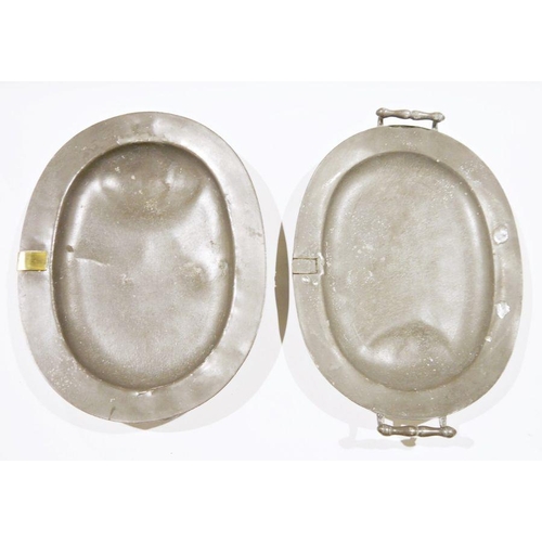 135 - Two 19th century pewter two-handled warming trays, each of oval form with well, one with brass cover... 