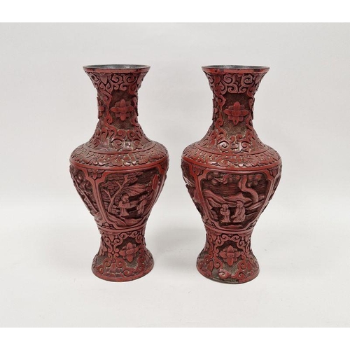 82 - Pair of Chinese carved cinnabar vases, each carved with dense scrolls and flowerheads above panels o... 