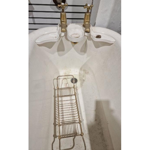 1248 - Vintage cast iron roll-top bath . 208 cms long, with brass taps and integral soap dishes and a cast ... 