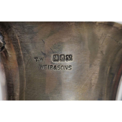 329 - Four early 20th century unengraved silver trophies, each being twin-handled and raised on pedestal, ... 