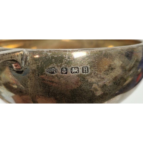 329 - Four early 20th century unengraved silver trophies, each being twin-handled and raised on pedestal, ... 