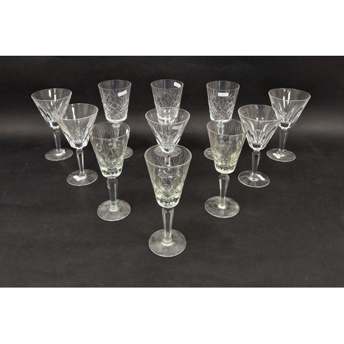 56 - Five Waterford large cut glass wine glasses, etched marks, with lappet-cut conical bowls on faceted ... 