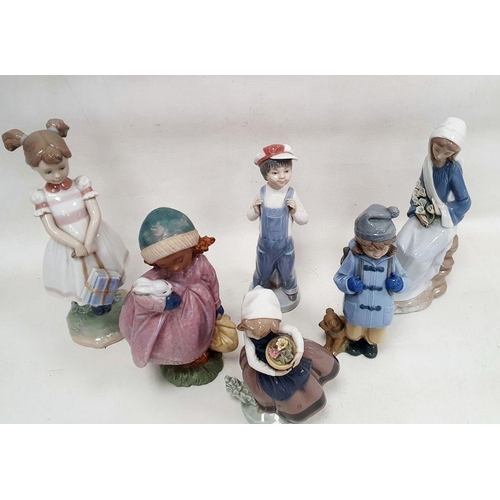 10 - Five Lladro figures of children including a girl holding a white rabbit, another standing holding bo... 