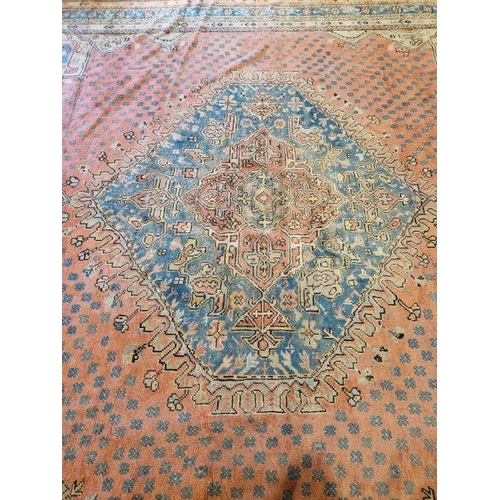 1033 - Large antique Heriz handmade wool pile carpet pink ground, with central hexagonal geometric medallio... 