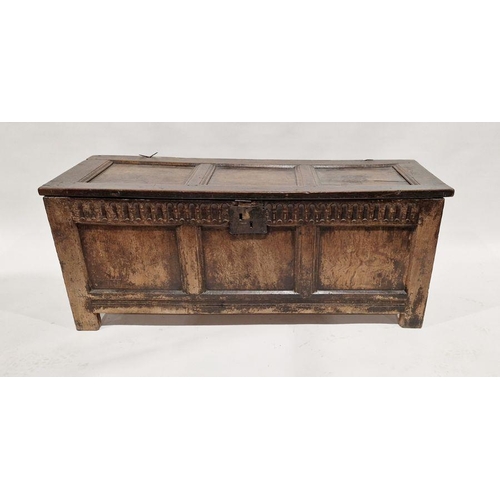 1049 - Late 17th century coffer having three panelled top and front, with carved frieze and on stile feet, ... 