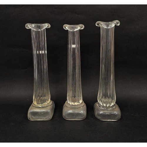 108 - Three Patrick Stern clear glass vases in the form of columns on plinth bases, each signed to base, h... 