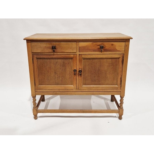 1106 - 20th century oak kitchen dresser base having two short drawers over two single door cupboards, on tu... 