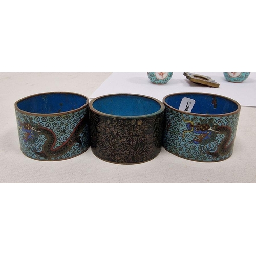 128 - Three Chinese cloisonne enamel napkin rings, late 19th/early 20th century, two decorated with scroll... 