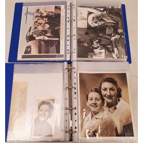 270 - Two folders of official publicity film stills to include Westerns, Disney, Laurel & Hardy, Charlie C... 