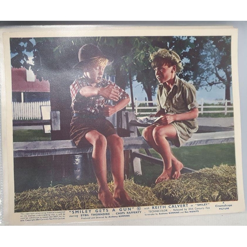 270 - Two folders of official publicity film stills to include Westerns, Disney, Laurel & Hardy, Charlie C... 