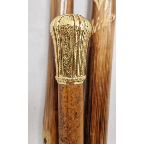 342 - Victorian yellow metal-mounted walking cane engraved with scrolls and strapwork, 94.5cm and two othe... 