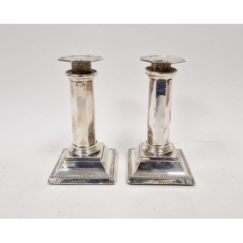 368B - Pair Edwardian silver candlesticks, each octagonal and panelled on square bevelled foot, 15cm high, ... 