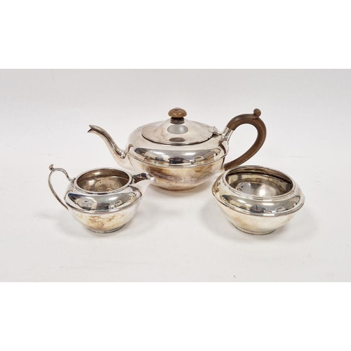 410 - George V three piece silver tea set, of bulbous form, the teapot with turned wooden knob and handle,... 