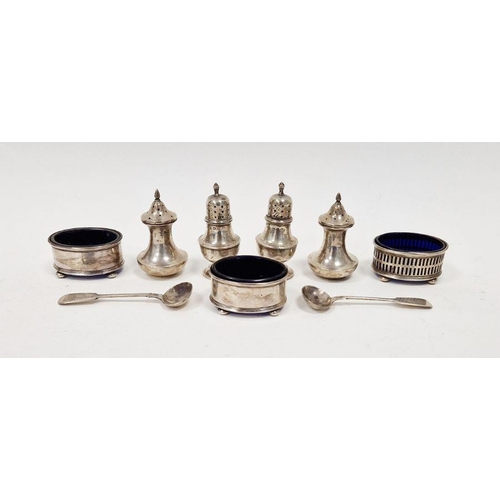 421 - Collection of silver condiments, to include pepper pots, open mustard pots of oval form with blue gl... 