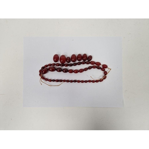 515 - String of red amber-coloured graduated oval beads