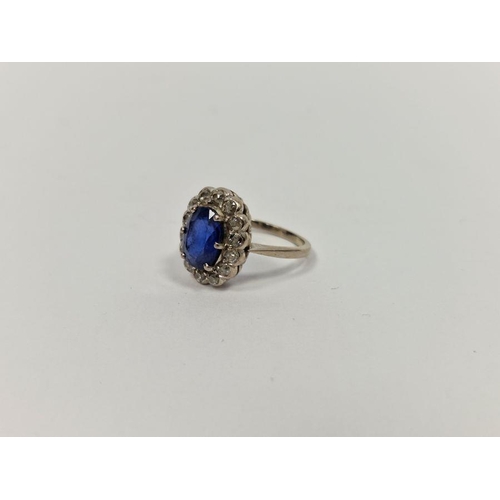 525 - 18ct white gold, sapphire and diamond cluster ring, the oval sapphire 2.3ct approx., the diamonds 1.... 