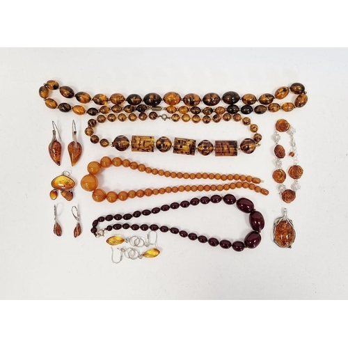 541 - Short string of red amber coloured graduated oval beads, another string of yellow-coloured amber bea... 