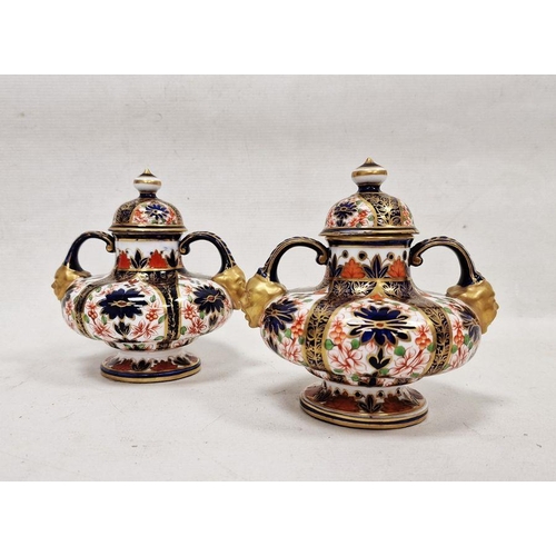 62 - Pair of Crown Derby imari pattern two-handled squat formed vases and domed covers, late 19th century... 