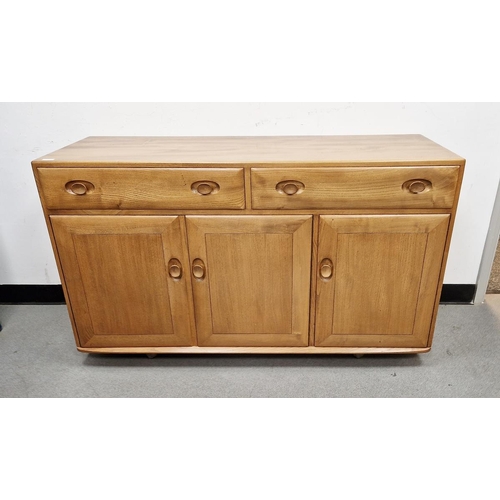 1025 - Ercol light elm 'Windsor' sideboard, having two drawers above a three cupboard doors, the right side... 