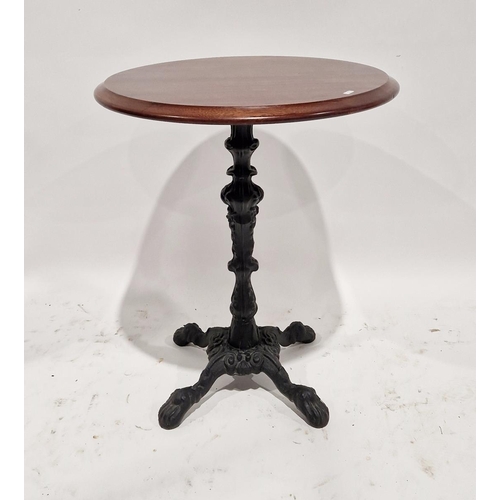 1028 - 20th century cast-iron based pub style table of circular form with mahogany top having four lion's p... 