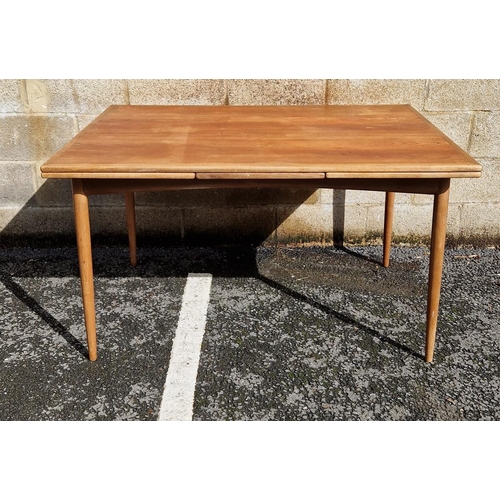 1071 - Mid-century teak draw-leaf dining table, of rectangular form, on rounded tapering legs, possibly by ... 