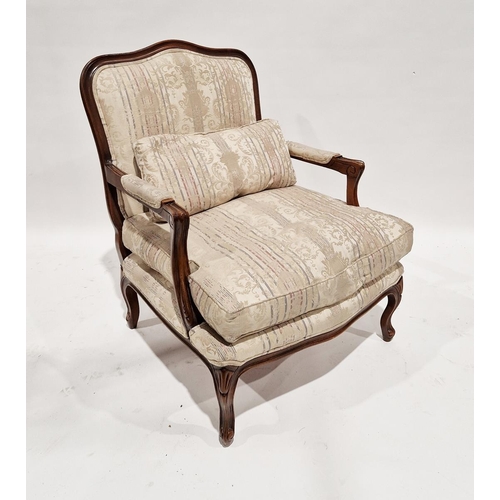 1197A - Two walnut framed carved upholstered armchairs, 20th century, one with scroll arm rests and foliate ... 