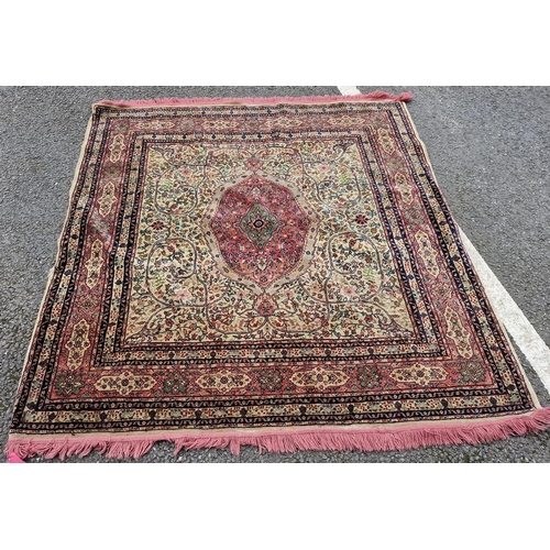 1266 - Middle Eastern pink and green ground rug, the central pink and green foliate medallion reserved agai... 