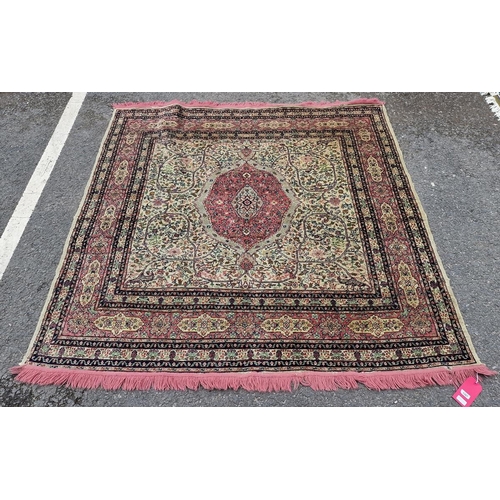 1267 - Middle Eastern pink and green ground rug, the central pink and green foliate medallion reserved agai... 