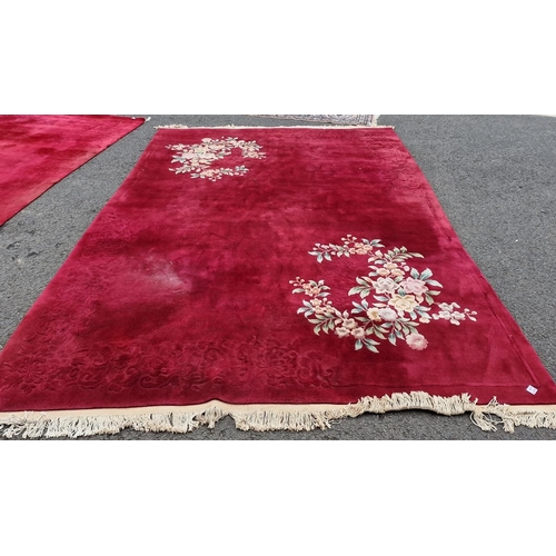 1269 - Contemporary Chinese superwash red ground carpet decorated with flowers and prunus, within fringed c... 