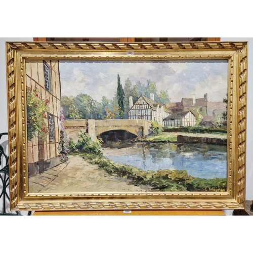 357 - C Wiegman 
 Oil on canvas
 River landscape with bridge and half timbered buildings, signed lower rig... 