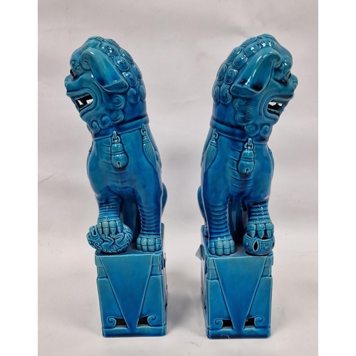 89 - Pair of Chinese Kangxi-style turquoise-glazed models of lion dogs, 20th century, each modelled with ... 