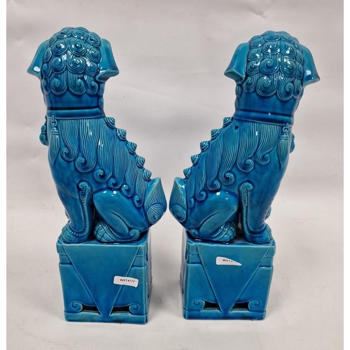 89 - Pair of Chinese Kangxi-style turquoise-glazed models of lion dogs, 20th century, each modelled with ... 