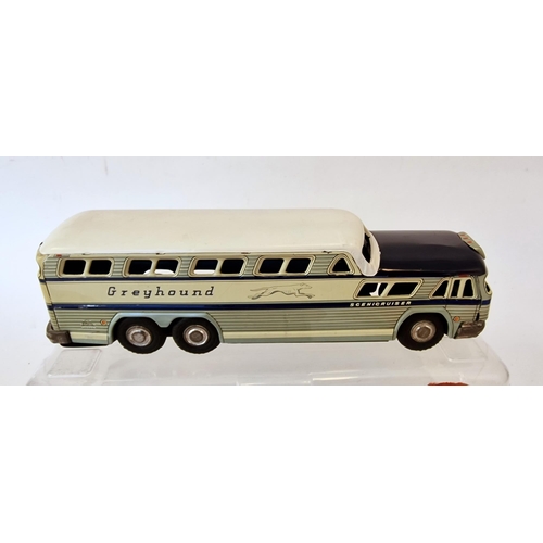 506 - Stone, Japan tinplate Scenicruiser Greyhound bus in blue and white, boxed, and a clockwork orange an... 