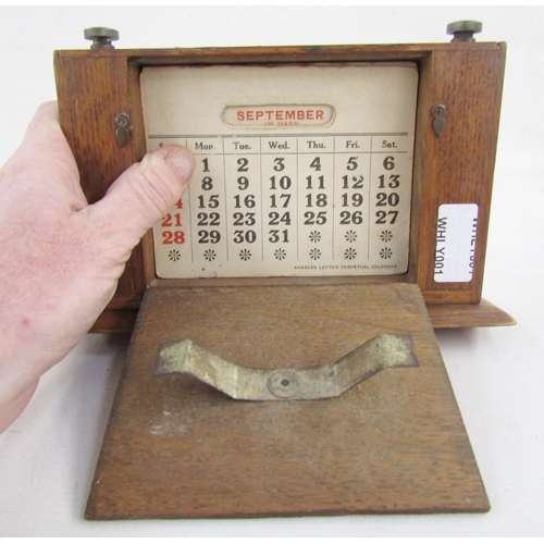 106 - Silver mounted stained wood perpetual desk calendar, having raised scroll border, silver front panel... 