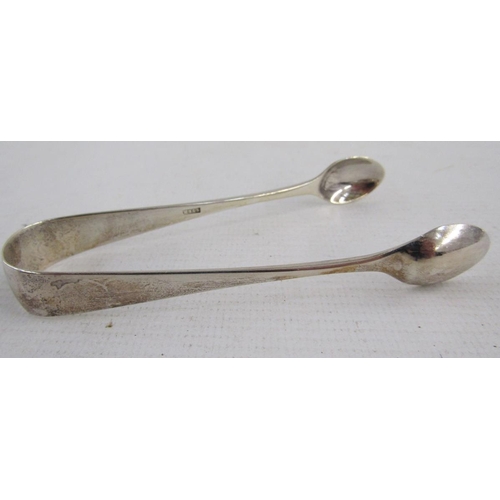 113 - Three silver sugar tongs, comprising: a George III example of plain form, hallmarked London, 1782, m... 