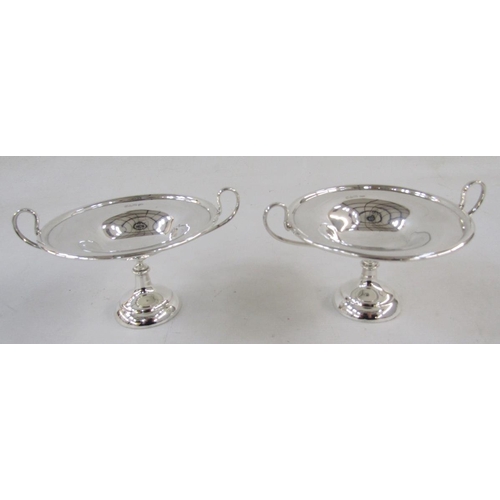 116 - Pair of George V footed two handled sweetmeat tazzas, each with loop handles, on domed and filled fe... 